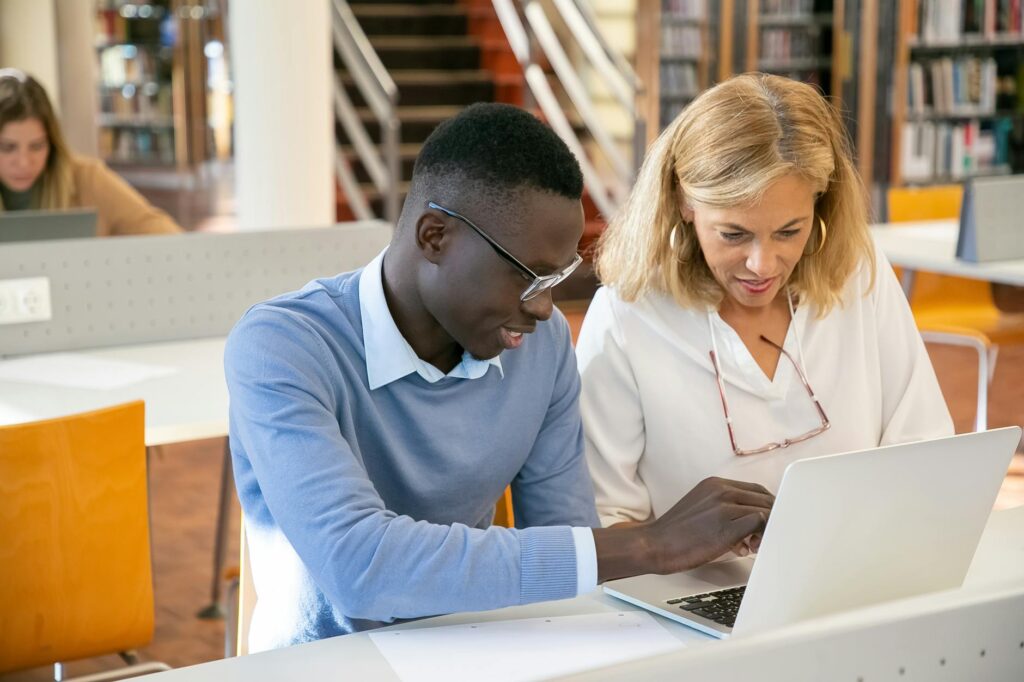 diverse graduate students collaborating on research project at university campus