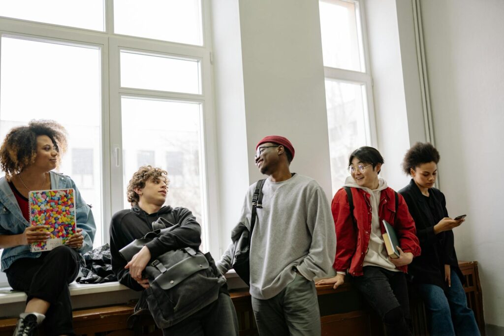 diverse group of high school seniors filling out college financial aid applications together