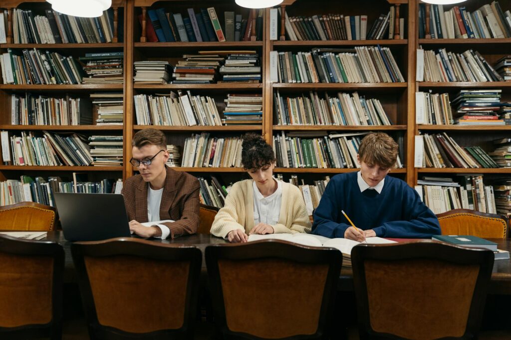 first generation college student reviewing scholarship application documents at a library desk