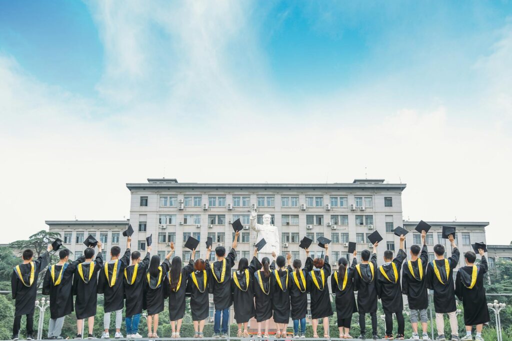 prestigious university campus with graduate students walking in academic regalia