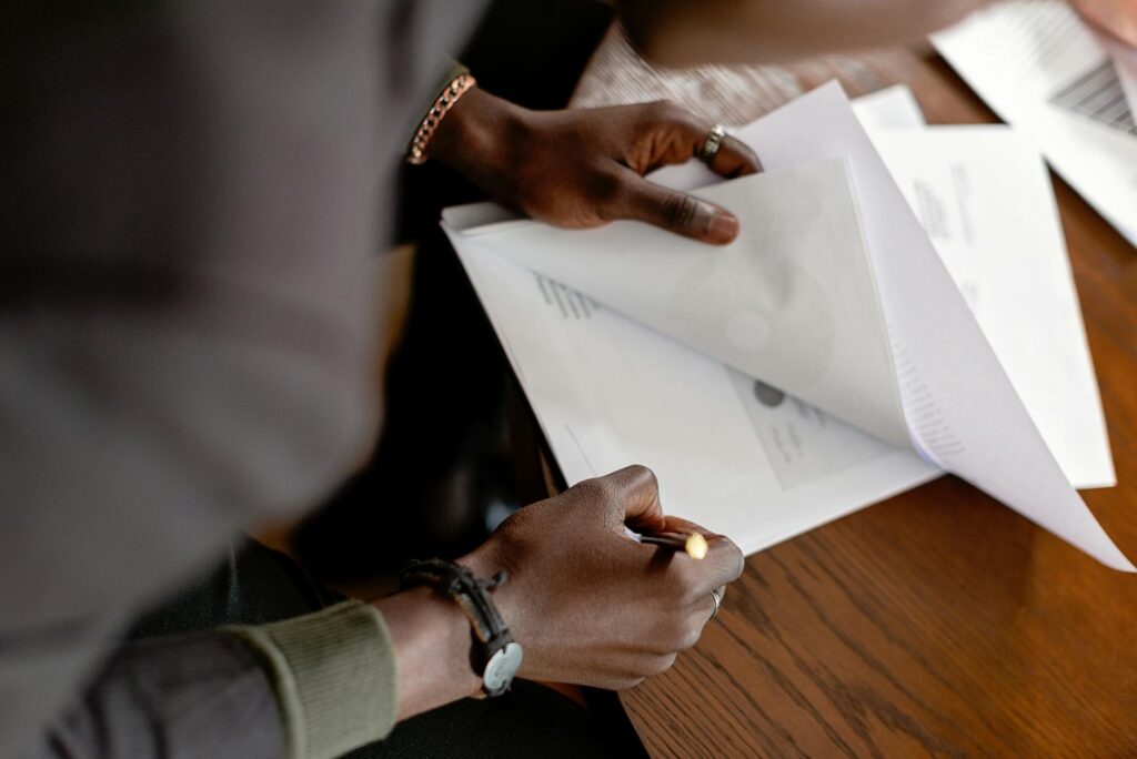professional adult reviewing scholarship documents at office desk