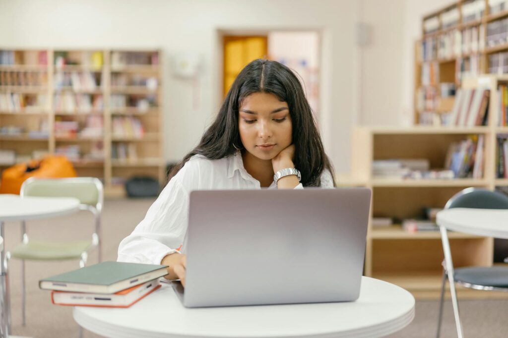 student reading scholarship eligibility requirements on laptop