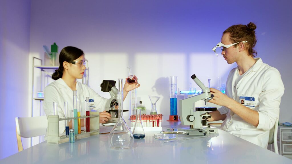 diverse group of STEM students collaborating on research project in university laboratory