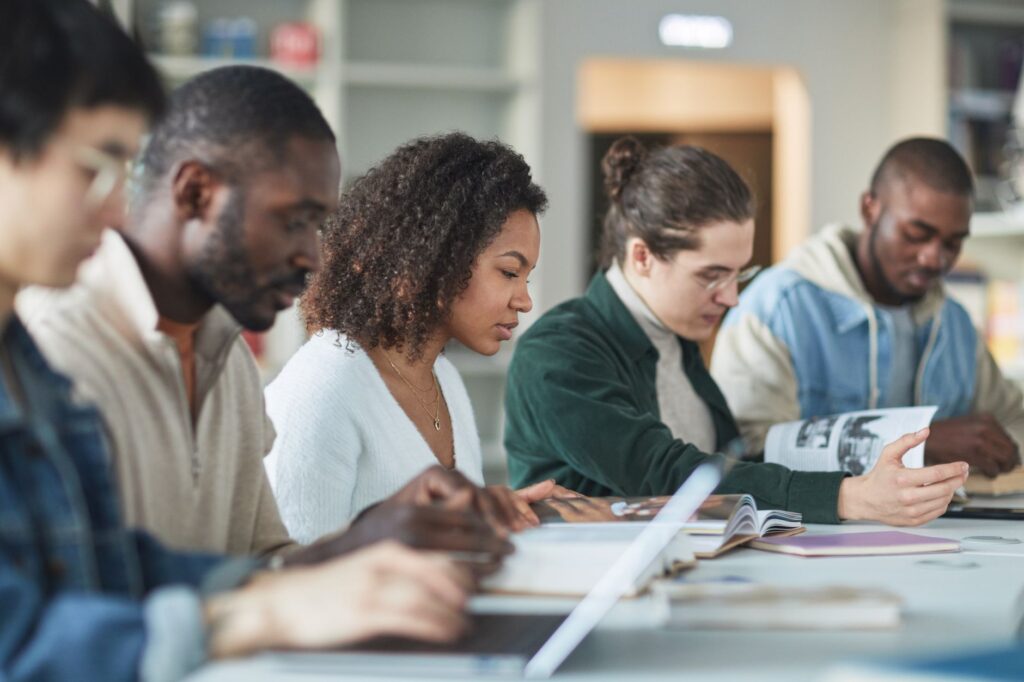 diverse minority college students studying together on campus