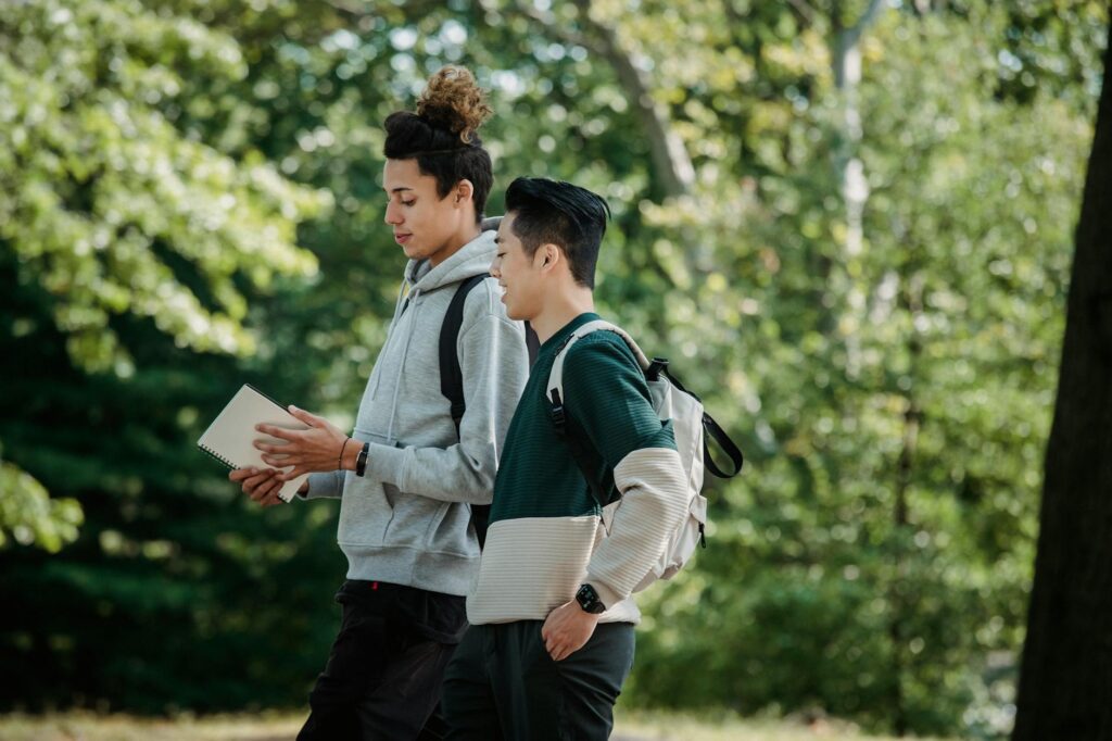 Nigerian students walking across a university campus in Lagos smiling