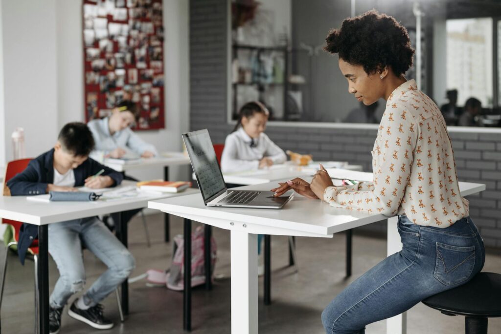 student celebrating scholarship acceptance letter at desk with laptop
