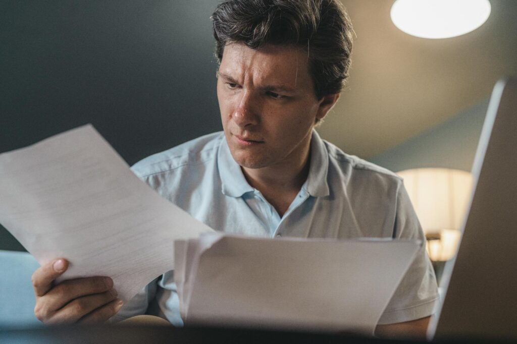 student reviewing financial aid documents and grant paperwork at a desk